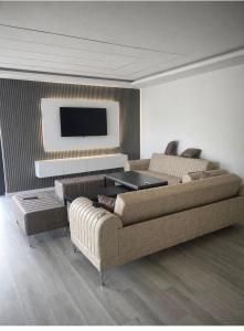 a living room with a couch and a tv at Villa ZANS in Gradačac