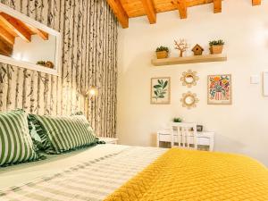 a bedroom with a bed with a yellow blanket at B&B La Borasca in Casalpusterlengo