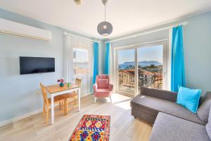 a living room with a couch and a table at Mavi Kıyı Suites in Kaş