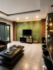 a living room with a tv and a couch and a table at Lloyds - 3 in Ermelo