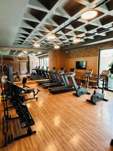 a gym with a row of exercise bikes and treadmills at Wish Residence Ap 710 in Maceió
