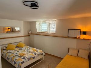 a bedroom with a bed and a window at Apartmani Grguric in Kornić
