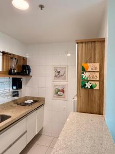 a kitchen with a sink and a counter top at Mandai Apartamentos in Cabo Frio