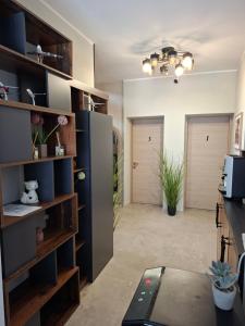 a living room with a refrigerator and two doors at Enza Suites in Shumen