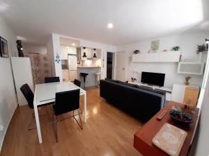 a living room with a table and a couch at Namaste in Sesimbra