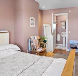 a bedroom with a bed and a bathroom with a sink at Southeast Getaway in Limerick