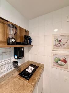a kitchen with a counter top with a blender on it at Mandai Apartamentos in Cabo Frio +66 photos