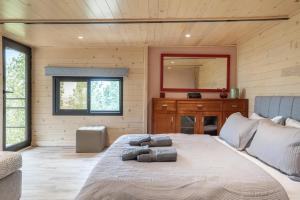 a bedroom with a large bed with a mirror at Maison Jwar - Charming Caravan Experience - Unique Summer Getaway in Jiwār al Ḩawz +173 photos