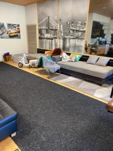 a living room with a large couch and chairs at The Workmans Palace in Jelgava