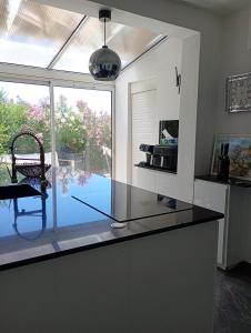 a kitchen with a counter with a view of a pool at Iris in Valras-Plage