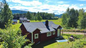 an aerial view of a red house in a field at Hus Hammerstrand in Hammarstrand