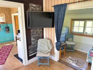 a living room with a flat screen tv on a wall at Hus Hammerstrand in Hammarstrand