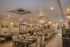 a large dining room with tables and chairs at Maharaja Resort Pvt Ltd in Butwāl