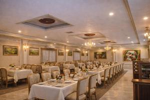 a banquet hall with tables and chairs in a room at Maharaja Resort Pvt Ltd in Butwāl