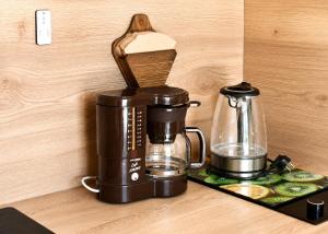 a coffeemaker sitting on a counter next to a coffee maker at Siebers-Ferienwohnung in Saupsdorf