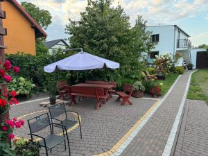 a patio with a picnic table and an umbrella at Apartament M6 w Centrum Wiela in Wiele