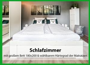 a large white bed in a bedroom with a mirror at MARKs Ferienwohnung in Bad Sachsa - waldnah, hundefreundlich, ruhig! Ideal für Paare mit Hund in Bad Sachsa +35 photos
