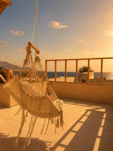 a net on a balcony with a view of the ocean at Isis Dahab in Dahab +2 photos