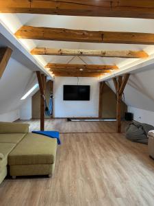 a living room with a couch and a flat screen tv at Studio-Style Apartment in Spreenhagen