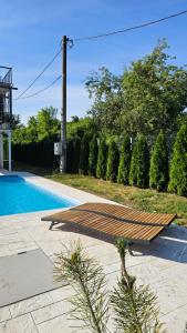 a swimming pool with a wooden ramp next to a fence at VRHouse Vorbis River House in Ada Skeljanska +23 photos