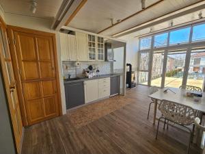 a large kitchen with a table and a counter top at VRHouse Vorbis River House in Ada Skeljanska