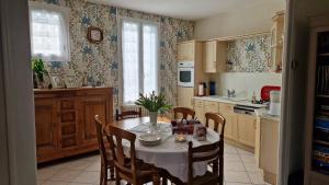 a kitchen with a table and chairs and a dining room at Gîte à 15km PUY duFOU 5pers 3chambres in Pouzauges