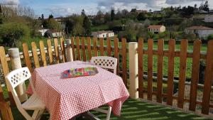 a table with a napkin on a table with a fence at Gîte à 15km PUY duFOU 5pers 3chambres in Pouzauges