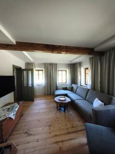 a living room with a couch and a table at Das Kothberg in Lunz am See