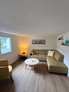 a living room with a couch and a table at Ferienwohnung Alte Metzgerei in Mesenich +22 photos