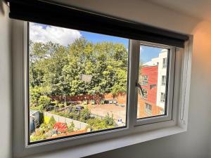 a window with a view of a street at The Lofton A Loft Above the Rest in Headingley
