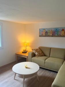 a living room with a couch and a table at Ferienwohnung Alte Metzgerei in Mesenich