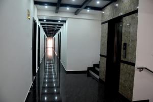 a hallway with a stairway with lights on it at Hotel Gateway Inn in Kushālnagar