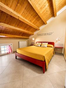 a bedroom with a bed in a room with wooden ceilings at Casa Vacanze Guccini in Porticello