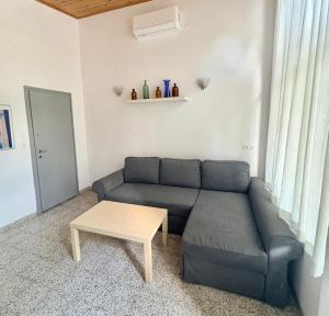 a living room with a couch and a table at Nádaspart Vendégház in Zánka