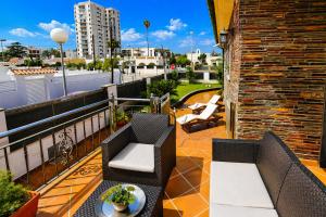 a balcony with two chairs and a table at Villa BARLOVENTO SPA in Cambrils +36 photos