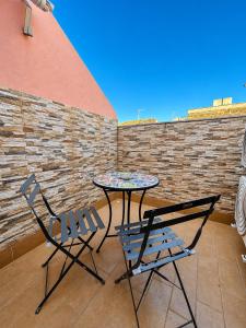 a table and two chairs on a patio at Casa Vacanze Guccini in Porticello