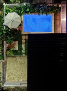 an overhead view of a pool and an umbrella at The Hide El Nido Villas in El Nido