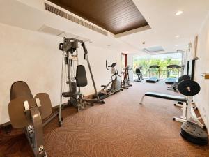 a gym with several treadmills and exercise bikes at Las Tortugas beach front condo in Khao Tao