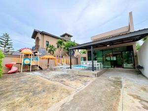a home with a playground and a house at A1-Mountain View Private Pool Villa-บางแสน in Chon Buri