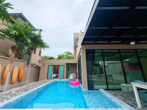 a swimming pool with a red frisbee in front of a house at A1-Mountain View Private Pool Villa-บางแสน in Chon Buri