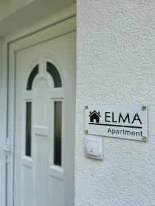 a door to a building with a sign on it at Apartman Elma in Jajce