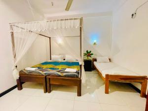 a bedroom with a canopy bed in a room at Soul Breeze in Arugam Bay