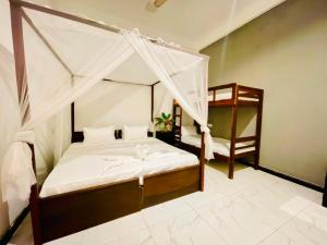 a bedroom with a canopy bed and a bunk bed at Soul Breeze in Arugam Bay +36 photos