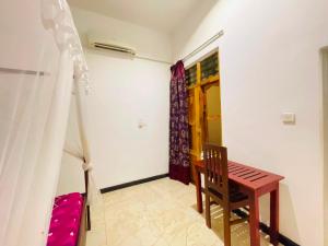 a room with a bed and a table and a chair at Soul Breeze in Arugam Bay