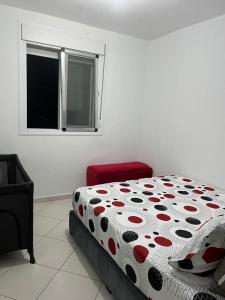 a bedroom with a bed with a polka dot blanket at Apartamento Familiar con Piscina en Bayt Al Bahr Asilah in Asilah +27 photos