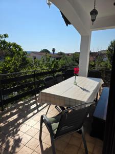 a patio with a table and chairs on a balcony at Villa Letina in Sukošan