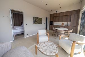a living room with a couch and chairs and a bed at North Mountain View Suites in Akureyri