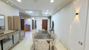 a kitchen and dining room with a table and chairs at Fadi house in Abū Kabīr