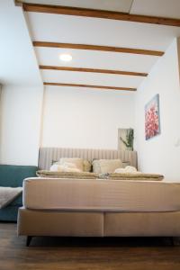 a large bed in a room with a ceiling at Studio Henigman in Dolenja Vas