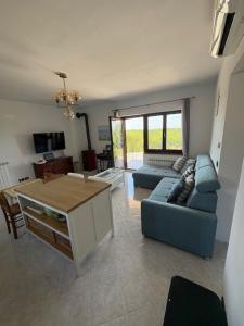a living room with a blue couch and a table at Casa Fortunata in Kaštel